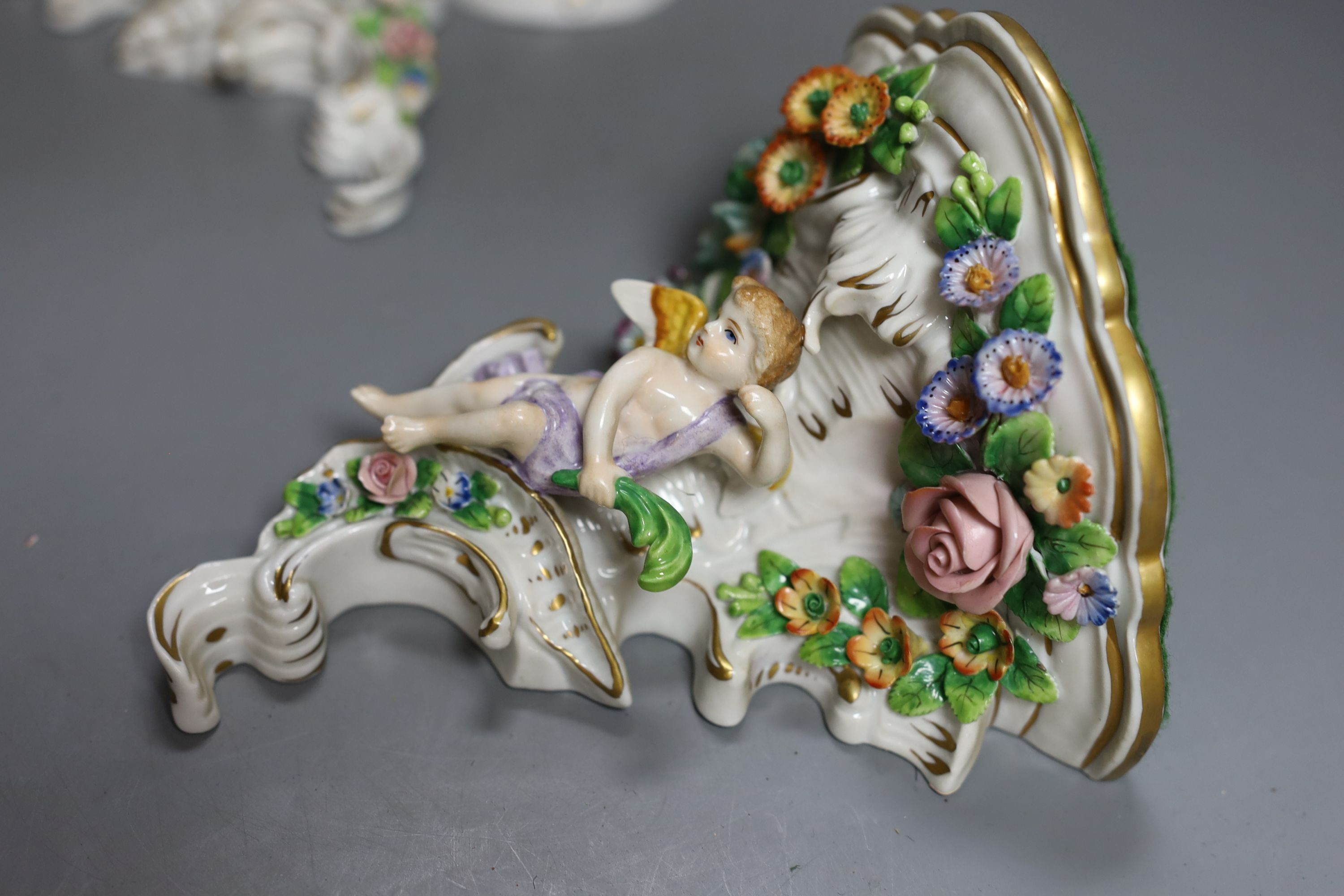 A pair of Sitzendorf wall brackets, 16cm tall, together with a Sitzendorf figure (3)